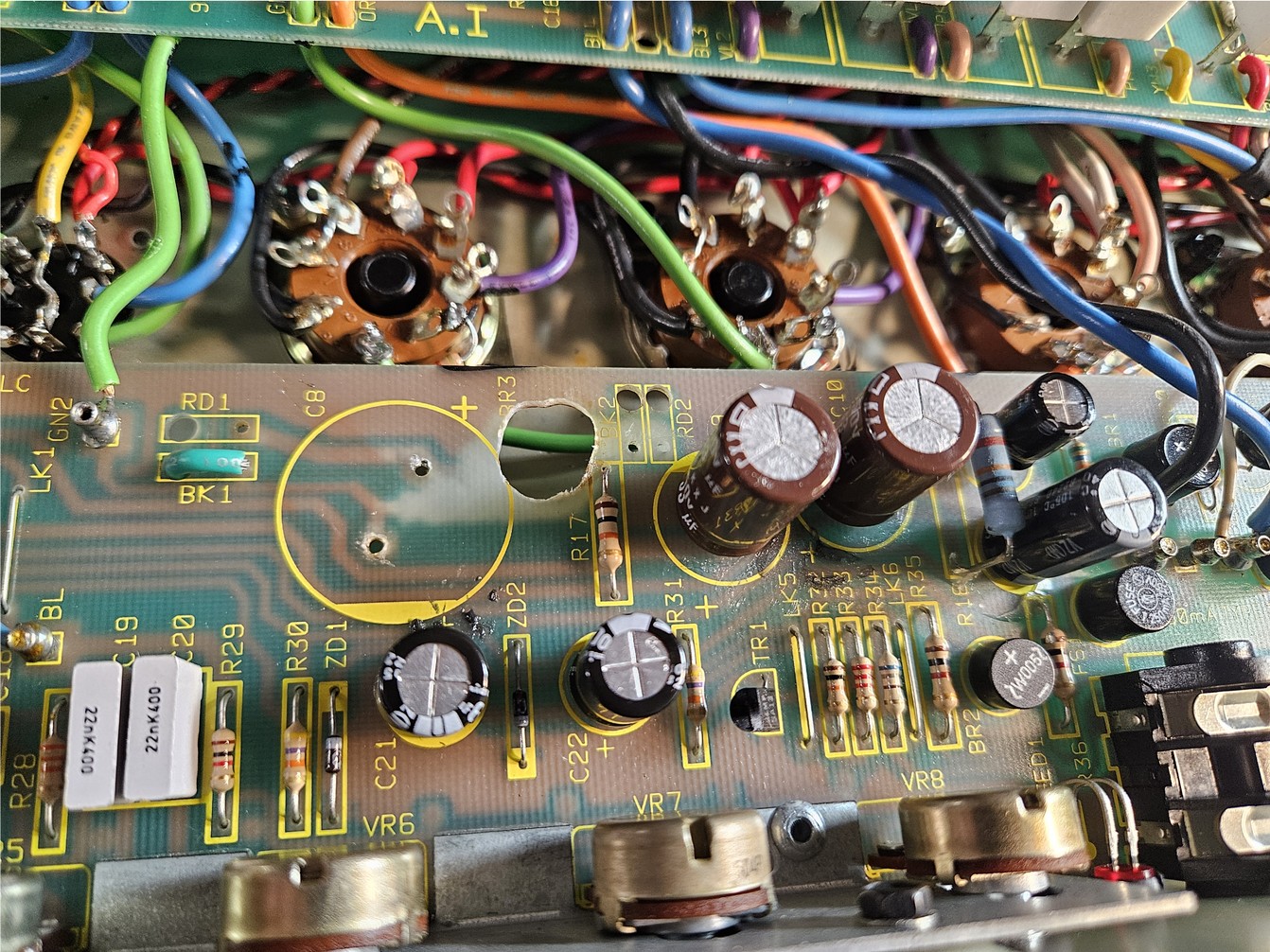 PCB with burnt sections drilled out